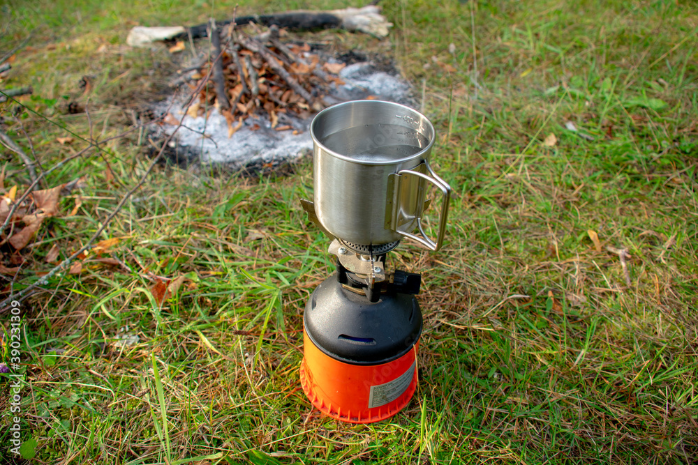 Cup on a portable gas camping stove in Markische Schweiz Buckow Brandenburg Germany Cup on a portable gas camping stove in Markische Schweiz Buckow Brandenburg Germany