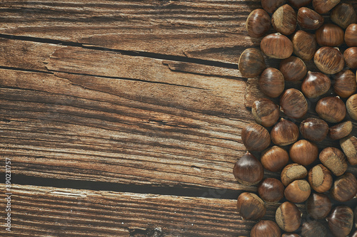 Top view of chestnuts on brown wooden background with copy space for your text.