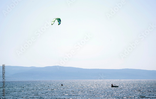 Tourists enjoying kite sports during a windy sunny day in Omis Resort, Croatia, Europe