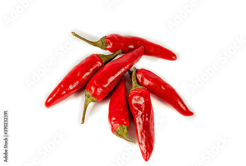 A group of several red hot peppers on a light background. Close-up