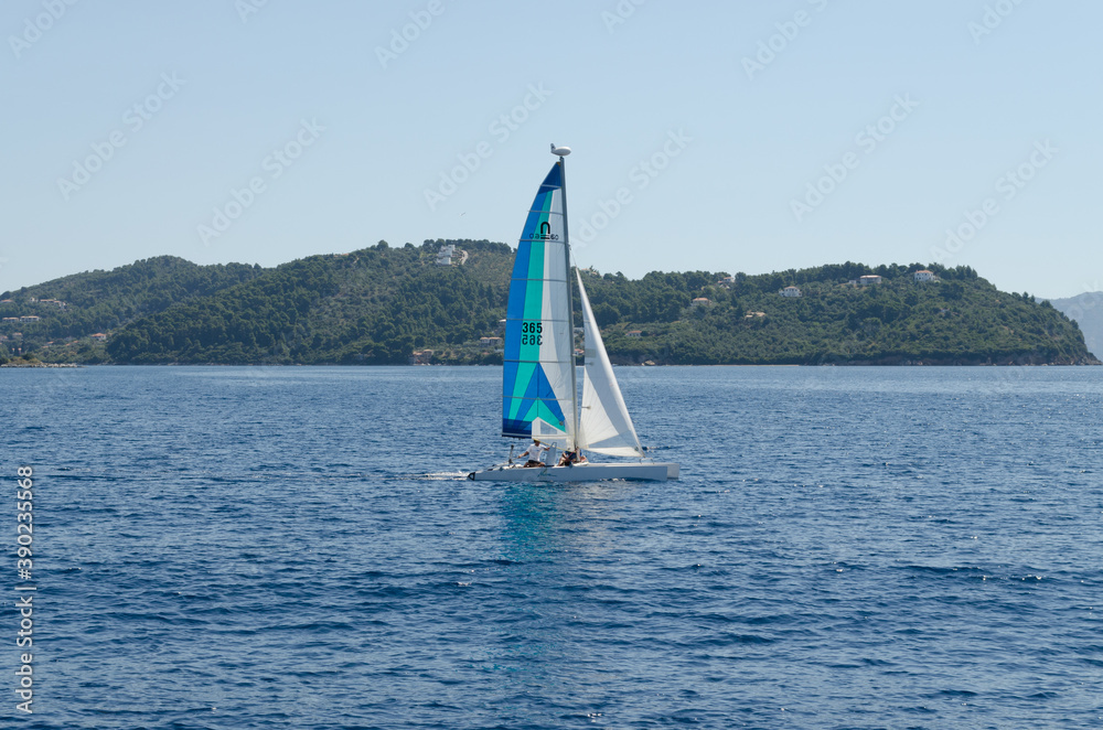 Naklejka premium Evia island, Greece - June 28. 2020: Sailing boat on the move on the high seas