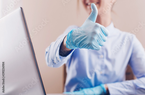 Woman works with laptop in meical gloves. Working. Laptop. Business concept. Gloves. 