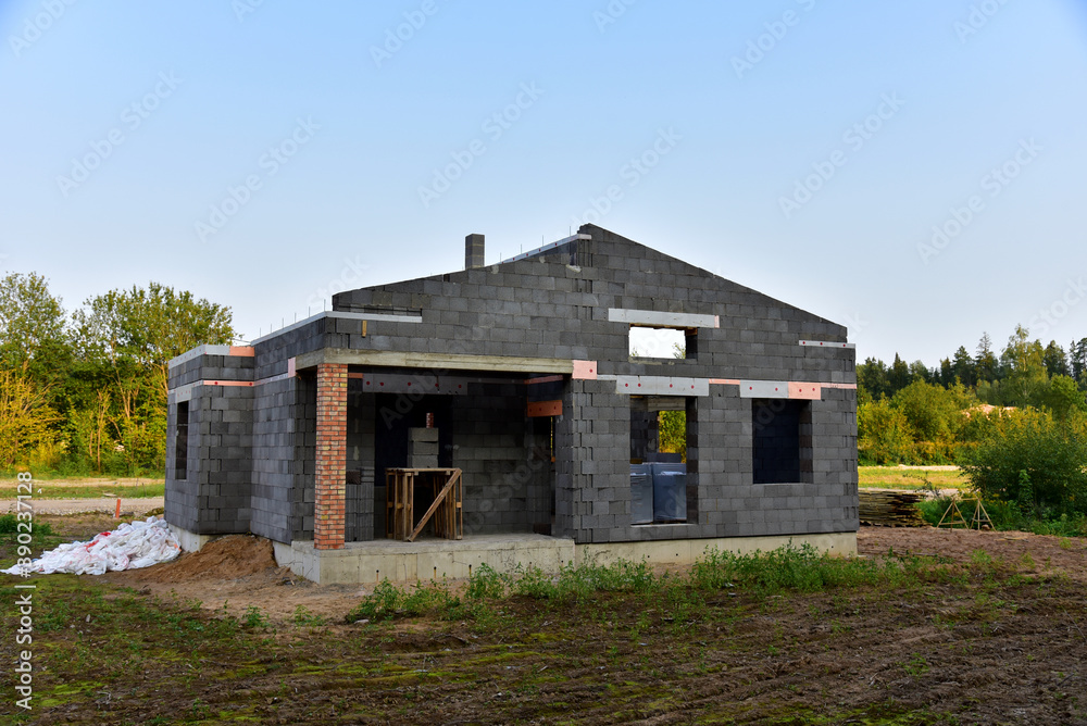 Building a house of expanded-clay concrete blocks. Unfinished private home of ceramsite concrete blocks on a construction site.Technology of construction work and laying bricks Building a house of expanded-clay concrete blocks. Unfinished private home of ceramsite concrete blocks on a construction site.Technology of construction work and laying bricks