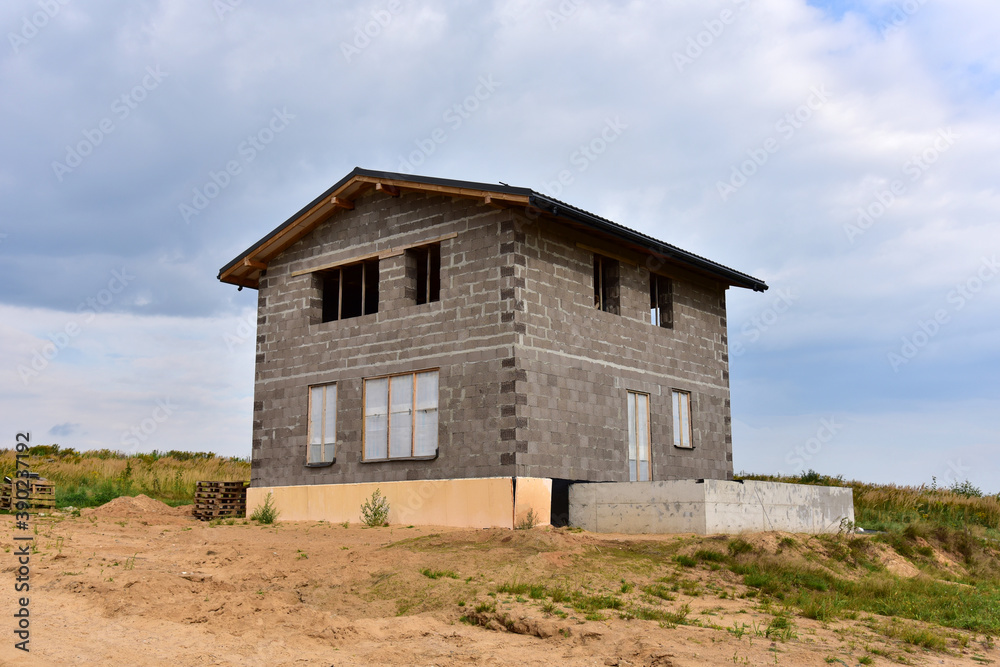 Building a house of expanded-clay concrete blocks. Unfinished private home of ceramsite concrete blocks on a construction site.Technology of construction work and laying bricks Building a house of expanded-clay concrete blocks. Unfinished private home of ceramsite concrete blocks on a construction site.Technology of construction work and laying bricks