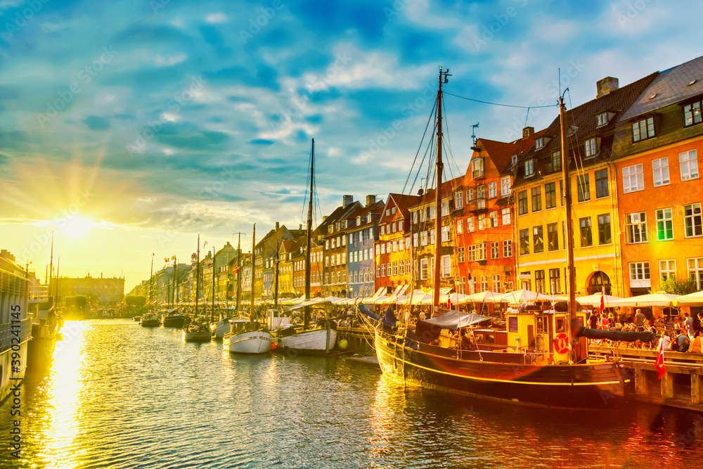 Copenhagen iconic view. Famous old Nyhavn port in the center of Copenhagen, Denmark during sunset