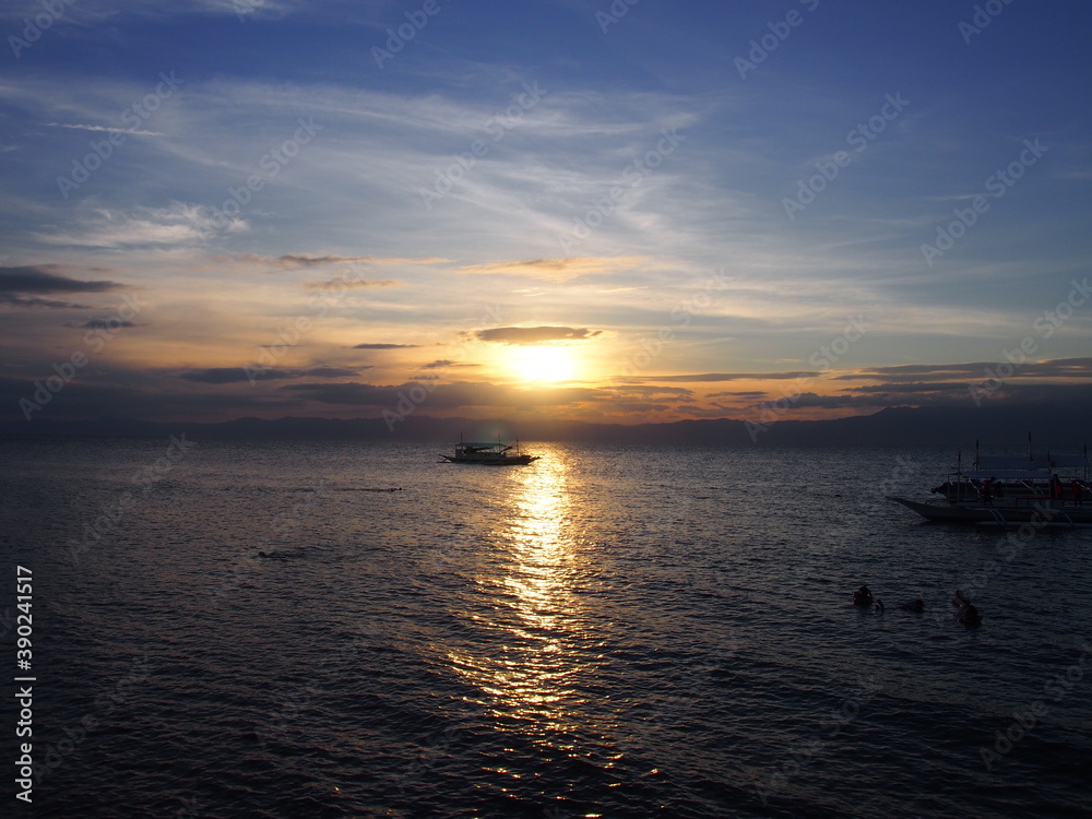 Beautiful sunsets and boats on the sea, Moalboal, Philippines Beautiful sunsets and boats on the sea, Moalboal, Philippines