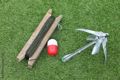 Photos Grappling hook with red and white float attached to security line
