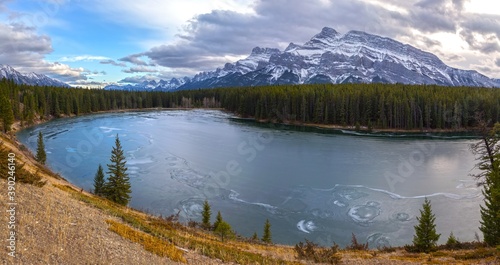 Fototapeta Naklejka Na Ścianę i Meble -  Panoramic Landscape View across Frozen Johnson Lake to Rundle Mountain Range near Banff in Canadian Rockies