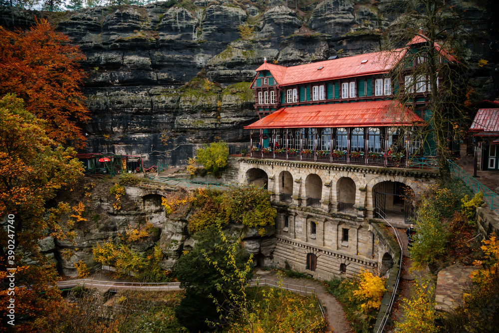 Obraz premium Panorama of holiday chateau, castle Falcon's Nest (Sokoli Hnizdo) near Prebischtor Gate (Pravcicka brana) in Bohemian Switzerland national park in autumn, Hrensko, Czech Republic