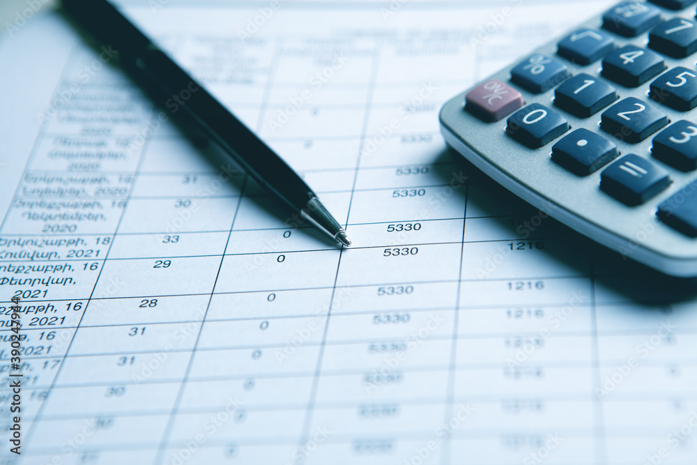 Close up calculator and financial report - accounting concept Close up calculator and financial report - accounting concept