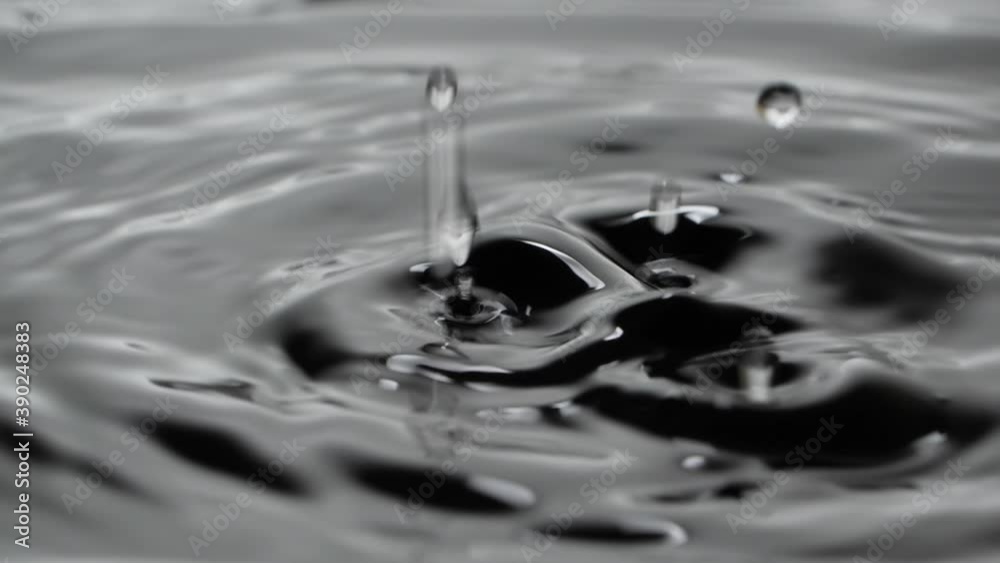 Water drops falling in slow motion into water Water drops falling in slow motion into water
