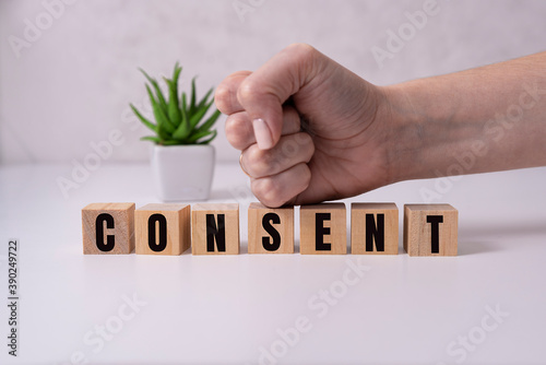 Consent - word from wooden blocks with letters, consent concept, top view on white background. photo