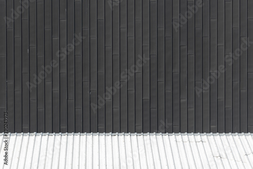 Black corrugated metal sheet background.