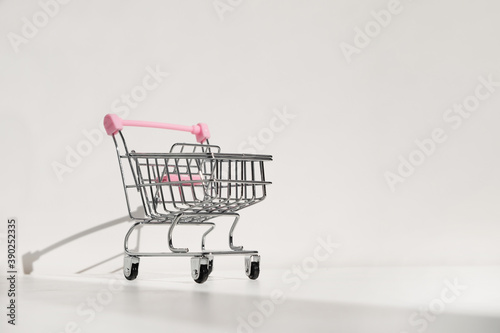 Shopping cart isolated on white background. Safe online shopping on quarantine concept. Empty supermarket shopping trolley with copy space © Николай Амосеев