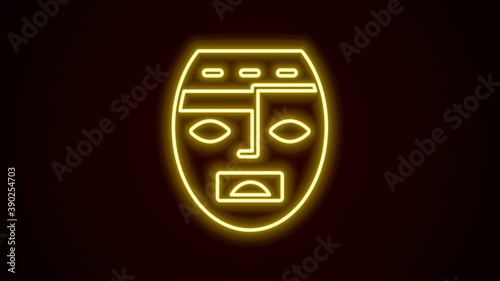 Glowing neon line Mexican mayan or aztec mask icon isolated on black background. 4K Video motion graphic animation