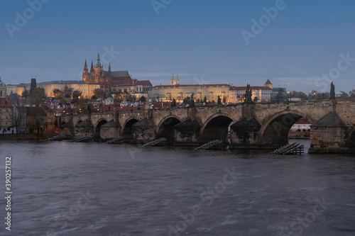 view of Prague Castle and the Cathedral of St. Vitus and Charles Bridge from the 14th century in the center of Prague at the sunset of the moon and the sky is colored