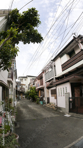  rural street photography of Kobe city showing houses, bridges, shops, rivers and public transportation
