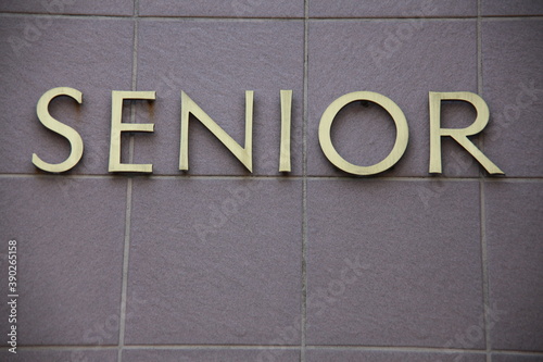Senior text word displayed on a wall outdoors.