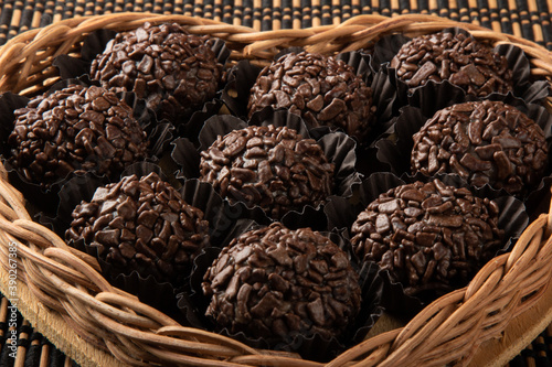 Brigadeiro.Traditional brazilian sweet chocolate in heart shaped basket.