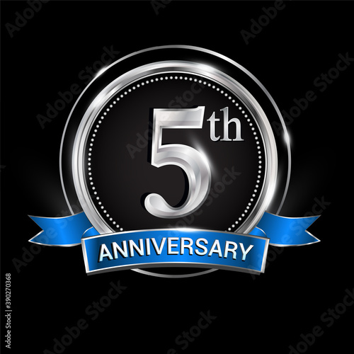 Celebrating 5th anniversary logo. with silver ring and blue ribbon.