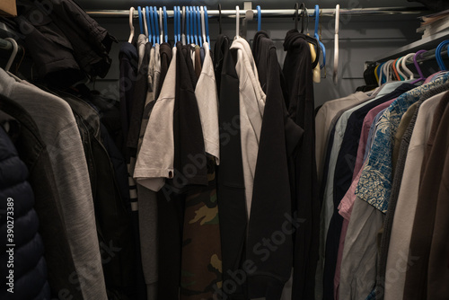 clothing on hangers in a walk-in closet 