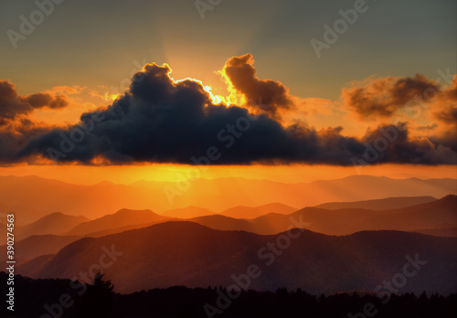 Fototapeta Naklejka Na Ścianę i Meble -  A beautiful golden sunset of the Blue Ridge mountains off of the Blue Ridge Parkway in North Carolina,  USA.