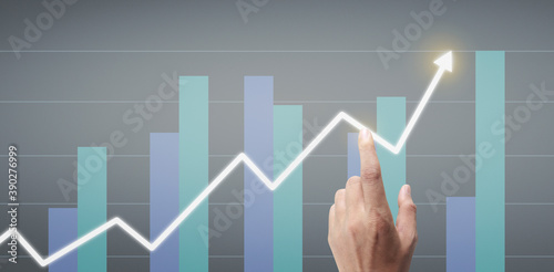 Hand touching a graphs of financial indicator accounting market economy analysis chart