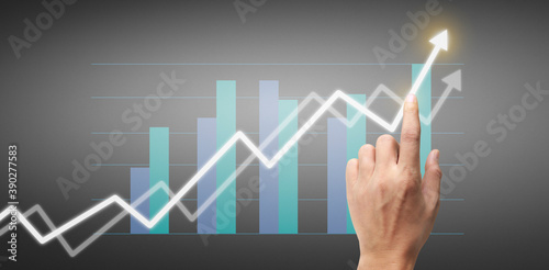 Hand touching a graphs of financial indicator accounting market economy analysis chart