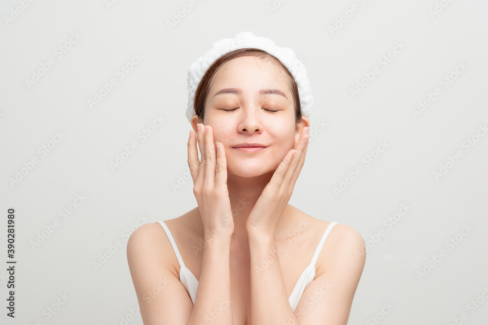 Young teen model applying body lotion on her face Young teen model applying body lotion on her face