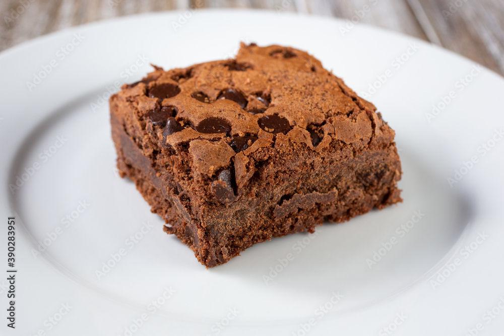 A closeup view of a chocolate chip brownie on a plate. A closeup view of a chocolate chip brownie on a plate.