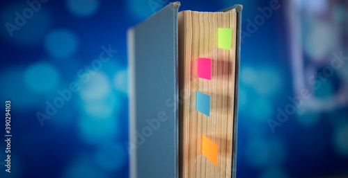 vintage book with bookmarks and blue bokeh