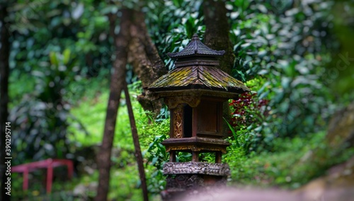 Ancient stone and wood lantern at the Coban Rondo Forest, East Java Indonesia