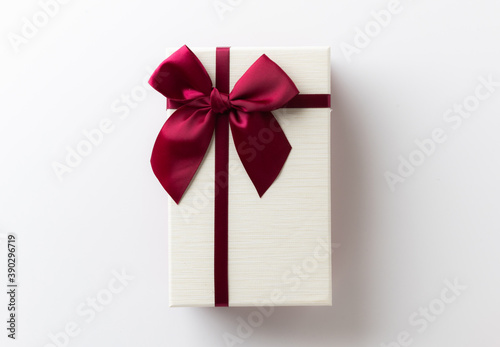 Gift box mockup on the white table with copy space. Merry christmas and happy new years background.