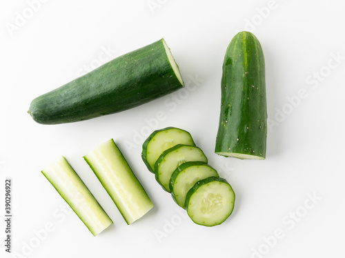 Pile Cucumber sliced into different ways ring and circle put on white table isolated background. Healthy vegetables and food.