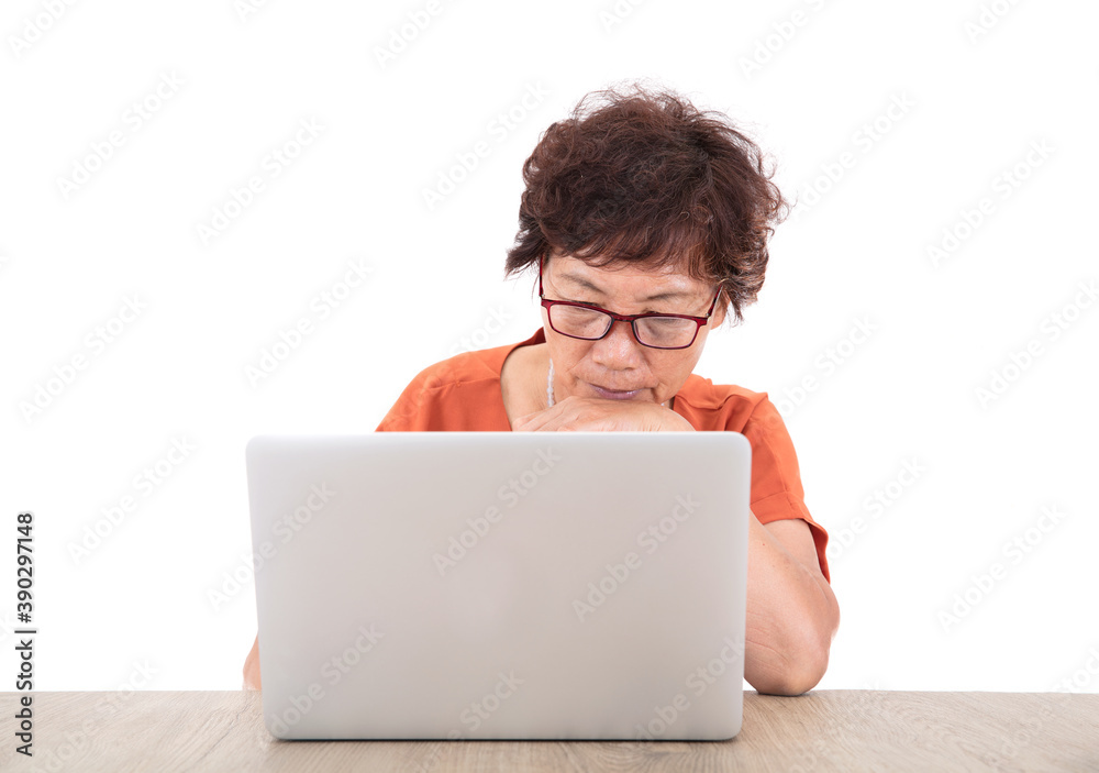 Old Chinese lady is sitting at the computer and typing seriously Old Chinese lady is sitting at the computer and typing seriously