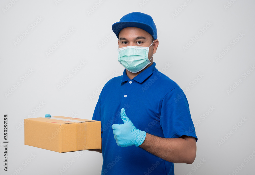 Delivery man with protective mask and gloves delivering parcels