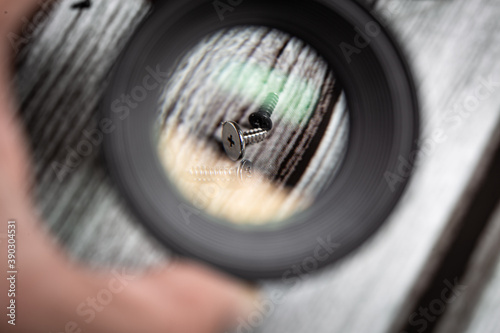 Smalls screws seen by a loupe photographic lens hand held photo