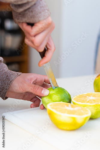 Hands of a young woman splitting a lemon