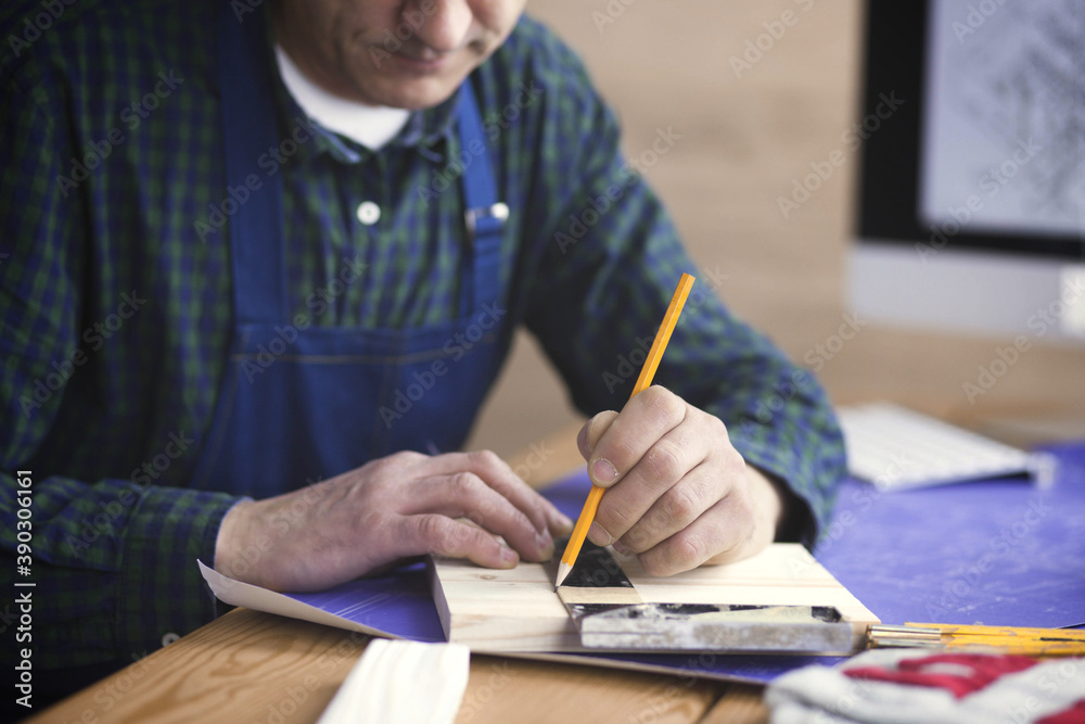 Engineer carpenter working on laptop and sketching project Engineer carpenter working on laptop and sketching project