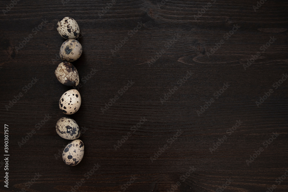 Quail eggs on a dark wooden background. Delicious and healthy Breakfast, lifestyle, ingredients for cooking different dishes. Photo of food. Quail eggs on a dark wooden background. Delicious and healthy Breakfast, lifestyle, ingredients for cooking different dishes. Photo of food.