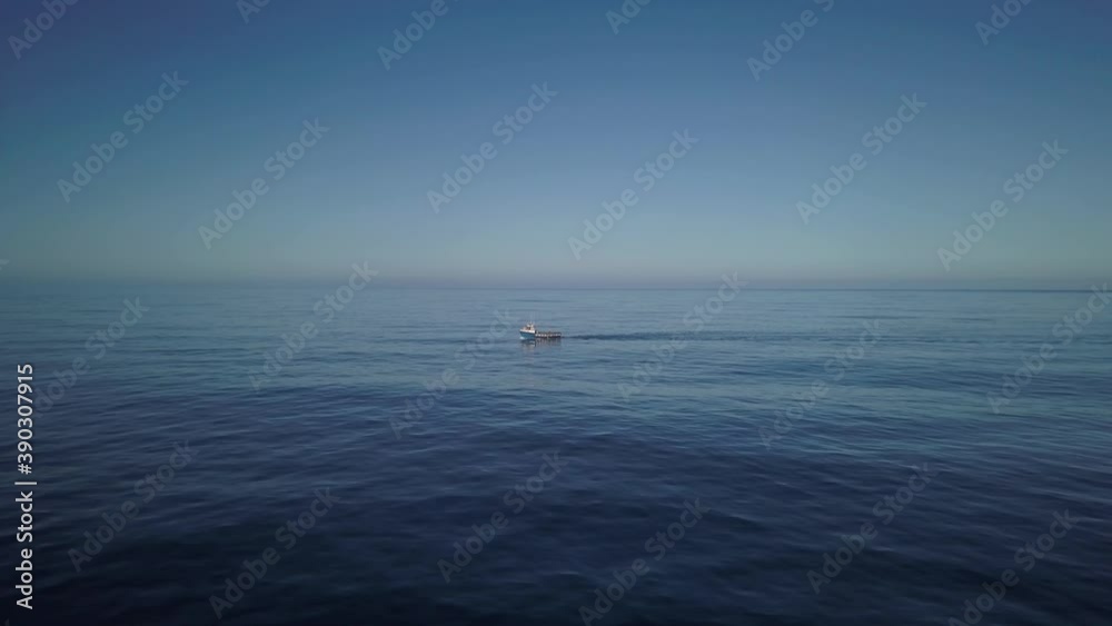 Aerial push in on a fishing vessel underway wide angle. Aerial push in on a fishing vessel underway wide angle.