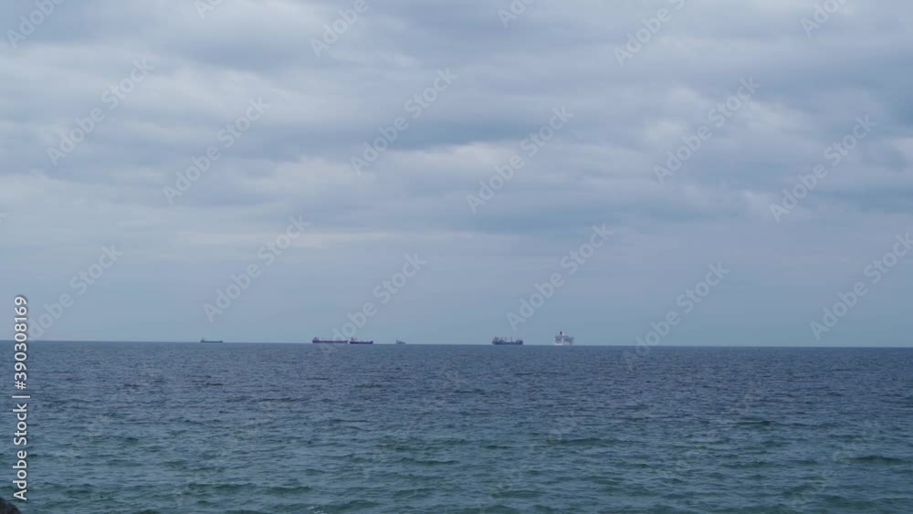 Large Cargo Ships in the Distance on an Overcast Day Large Cargo Ships in the Distance on an Overcast Day