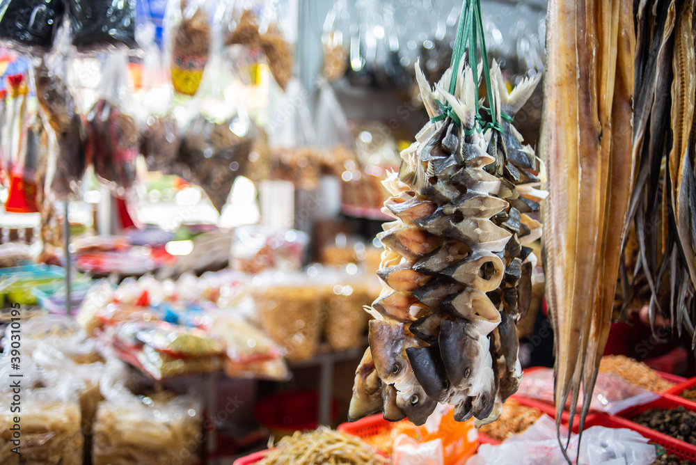 Dried salted fish and white pomfret hanging in the seafood shop