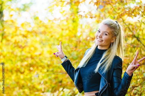 Fototapeta Naklejka Na Ścianę i Meble -  Blonde girl having fun in autumn park