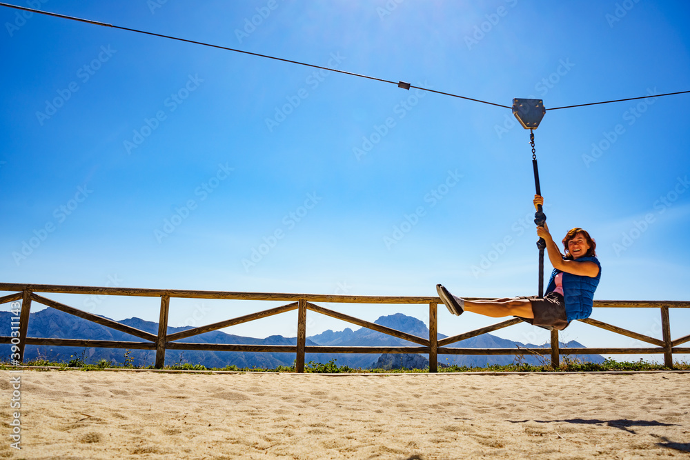 Adult woman having fun on zipline