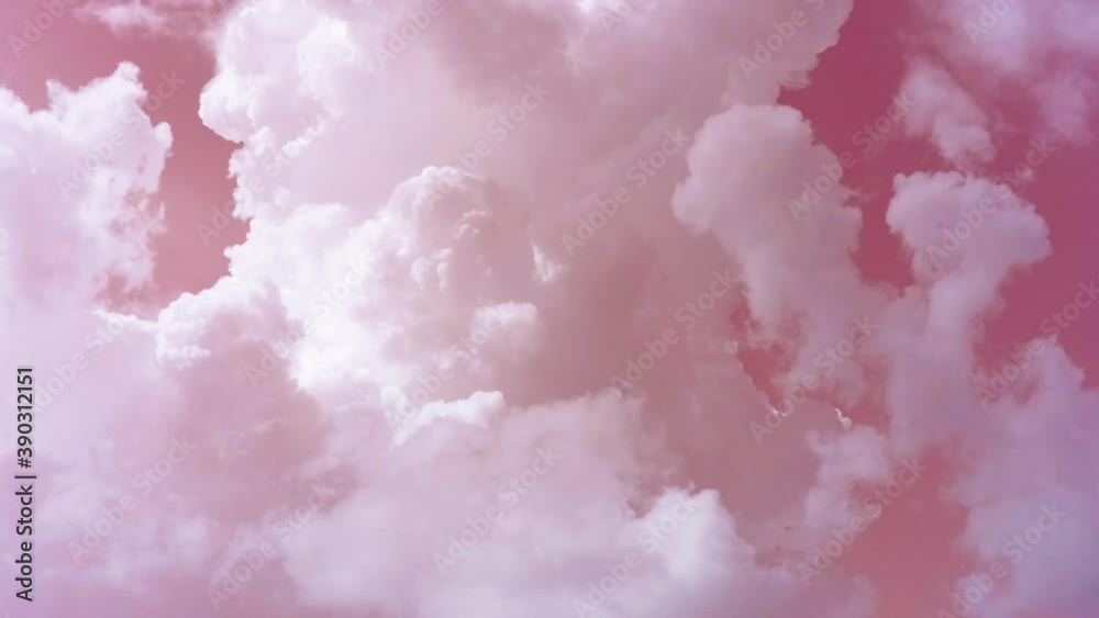 Thick white clouds swirl like smoke in the pink sky