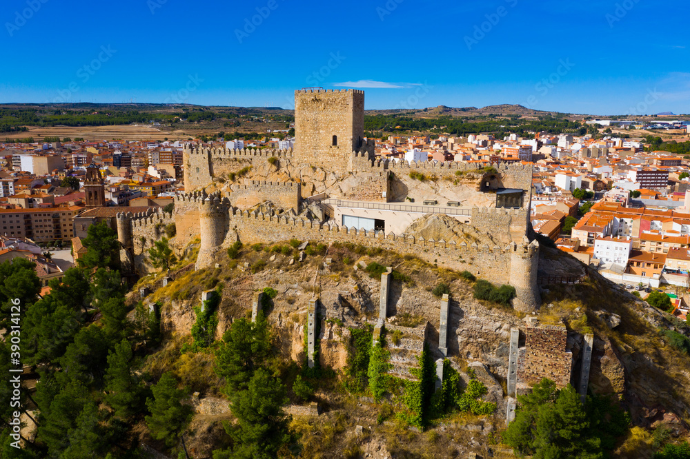 View from drone of historic center of Spanish city of Almansa overlooking ancient fortified Castle and bell-tower of Roman Catholic Church, province of Albacete