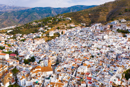 Aerial view of central areas of Competa overlooking parish Church of Assumption on sunny fall day, Andalusia, Spain © JackF