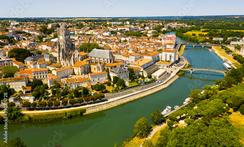Picturesque summer view of historic areas of Saintes located on Charente river looking out over cathedral bell tower in Flamboyant Gothic style, Charente-Maritime, France..