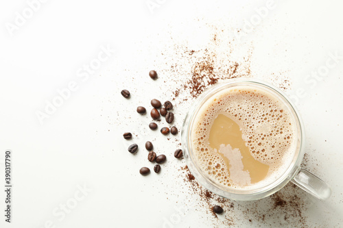 Cup of coffee and coffee beans on white background
